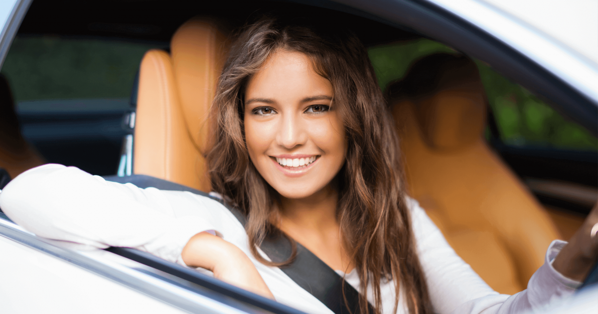 A Young Woman Sitting in the Driver Seat of a Car